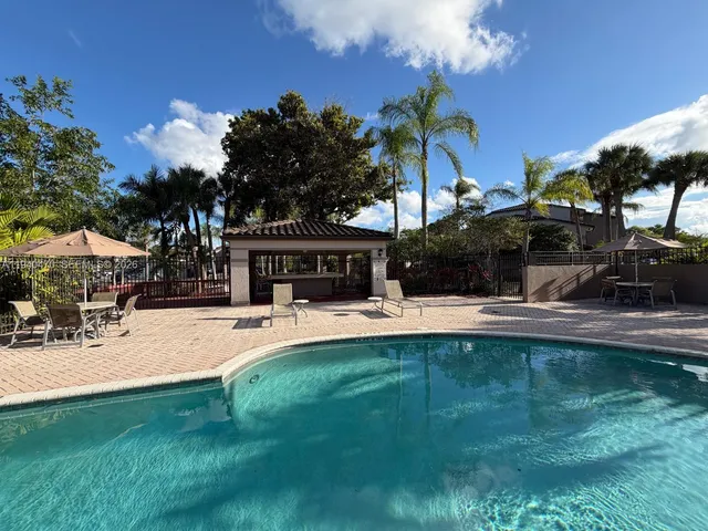 a view of a house with pool and sitting area