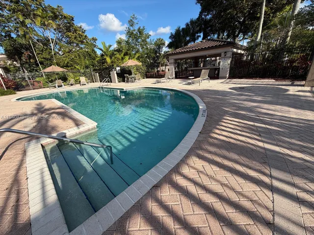 a backyard of a house with wooden floor and outdoor seating