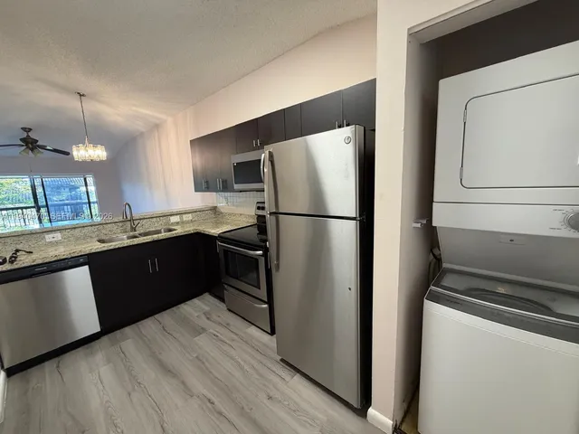 a kitchen with a refrigerator sink and microwave