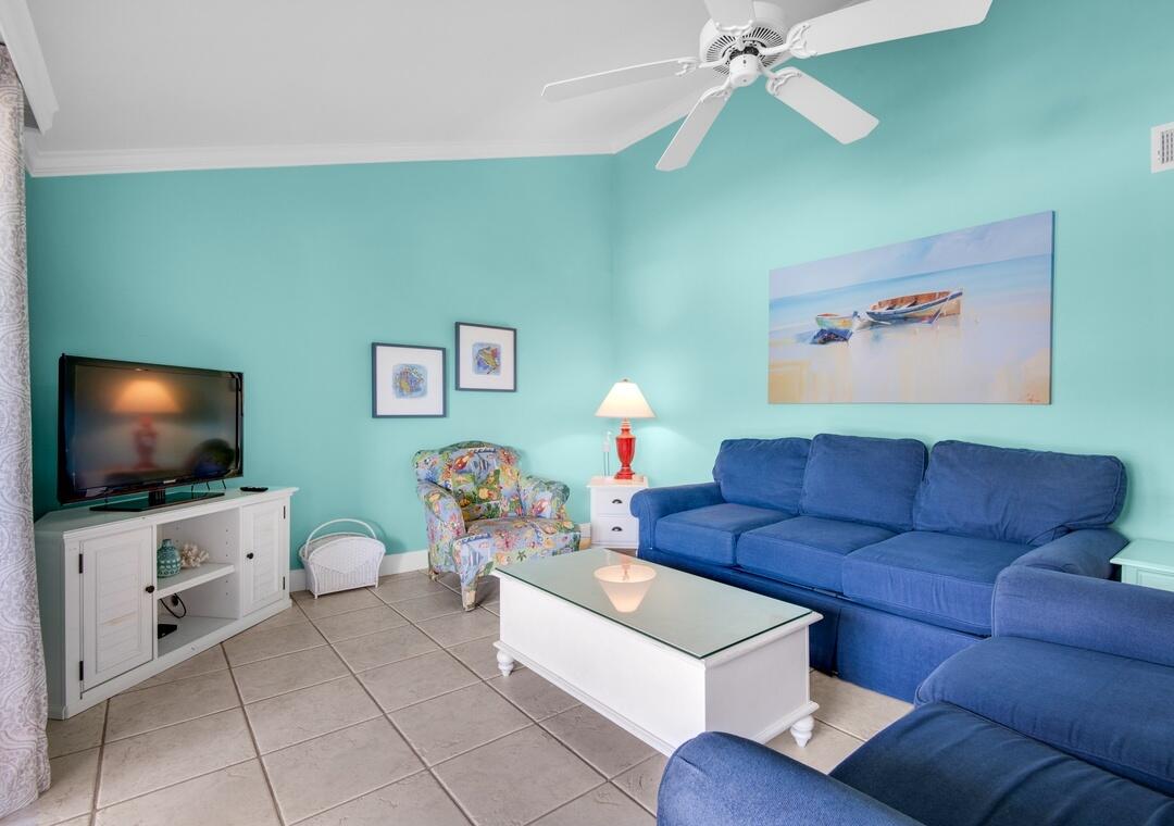 85 Breakwater Bay, Unit 10D Miramar Beach, FL 32550 - Photo 12 of 39 a living room with furniture and a flat screen tv