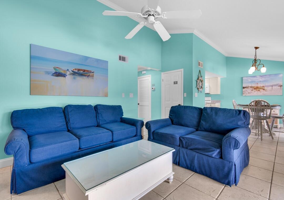 85 Breakwater Bay, Unit 10D Miramar Beach, FL 32550 - Photo 13 of 39 a living room with furniture and a chandelier