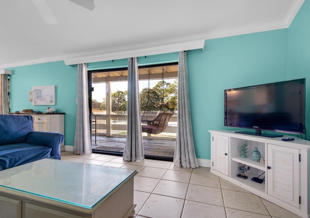 85 Breakwater Bay, Unit 10D Miramar Beach, FL 32550 - Photo 14 of 39 a living room with furniture and a flat screen tv