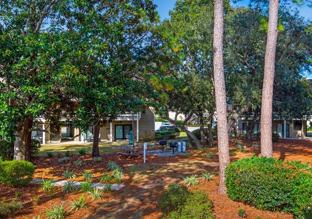 85 Breakwater Bay, Unit 10D Miramar Beach, FL 32550 - Photo 15 of 39 a view of a patio with table and chairs under an umbrella