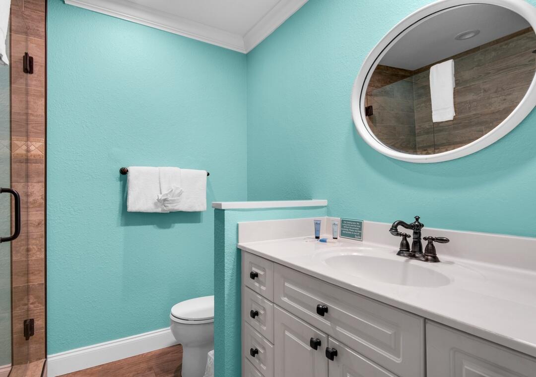 85 Breakwater Bay, Unit 10D Miramar Beach, FL 32550 - Photo 18 of 39 a bathroom with a toilet sink and mirror