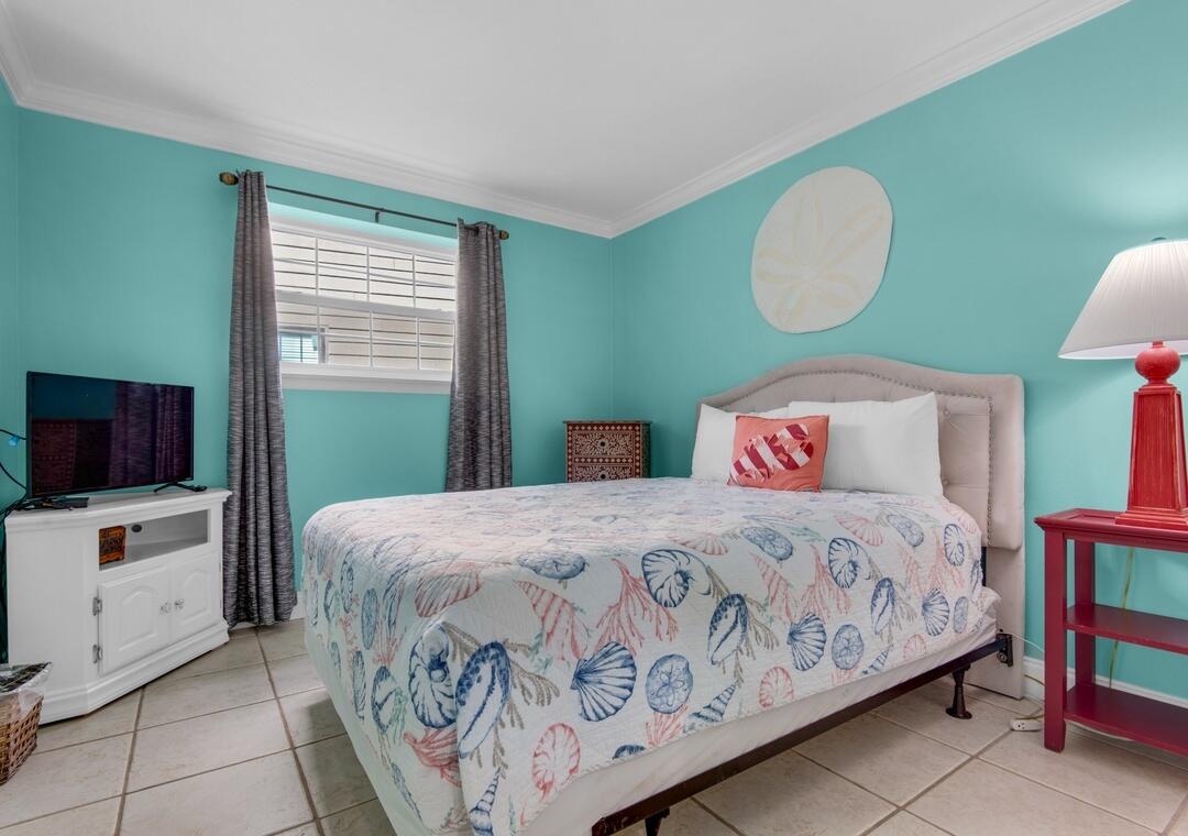 85 Breakwater Bay, Unit 10D Miramar Beach, FL 32550 - Photo 20 of 39 a bedroom with a bed and a flat screen tv