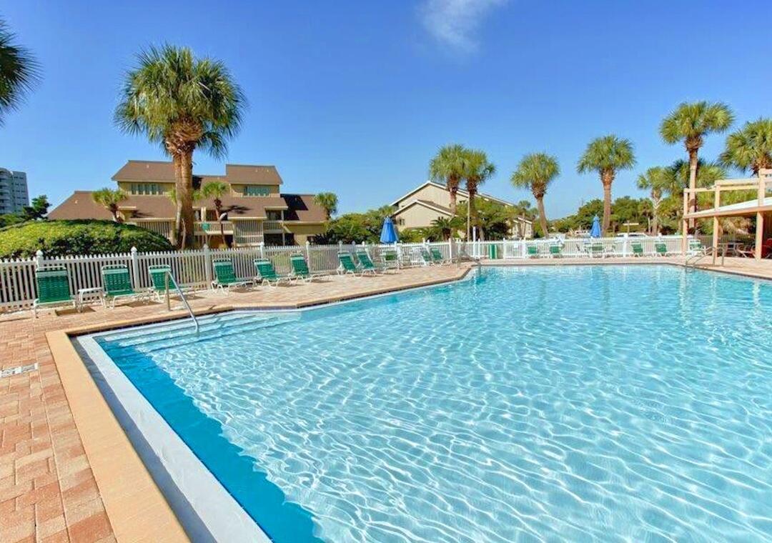 85 Breakwater Bay, Unit 10D Miramar Beach, FL 32550 - Photo 26 of 39 a view of a swimming pool and a yard