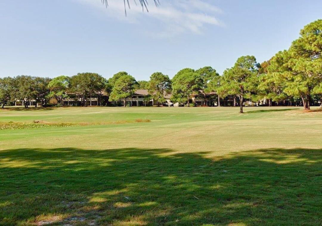 85 Breakwater Bay, Unit 10D Miramar Beach, FL 32550 - Photo 36 of 39 a view of an ocean with beach and trees in the background