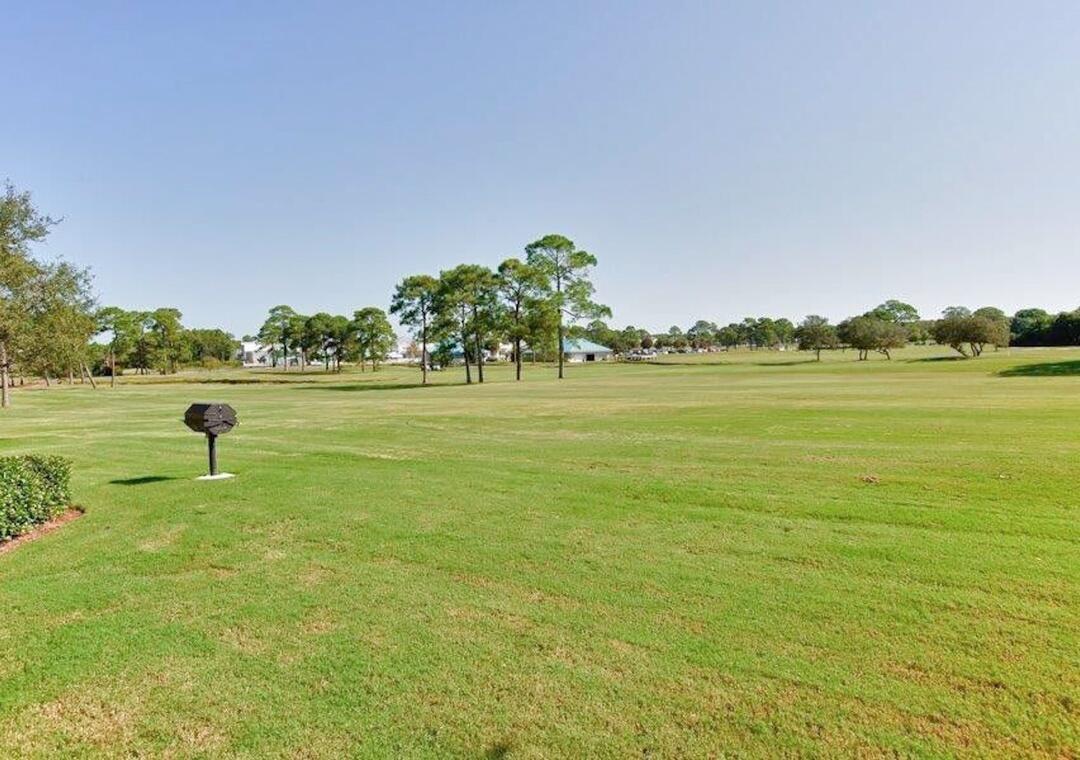 85 Breakwater Bay, Unit 10D Miramar Beach, FL 32550 - Photo 37 of 39 a view of a lake and a yard