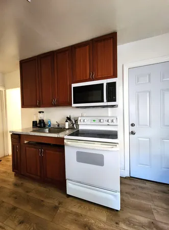 a kitchen with stainless steel appliances a stove microwave and cabinets