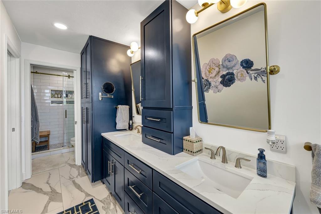 6549 Marissa Loop, Unit 21 Naples, FL 34108 - Photo 11 of 20 a bathroom with a sink and a mirror
