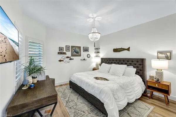 a bedroom with bed table and chair