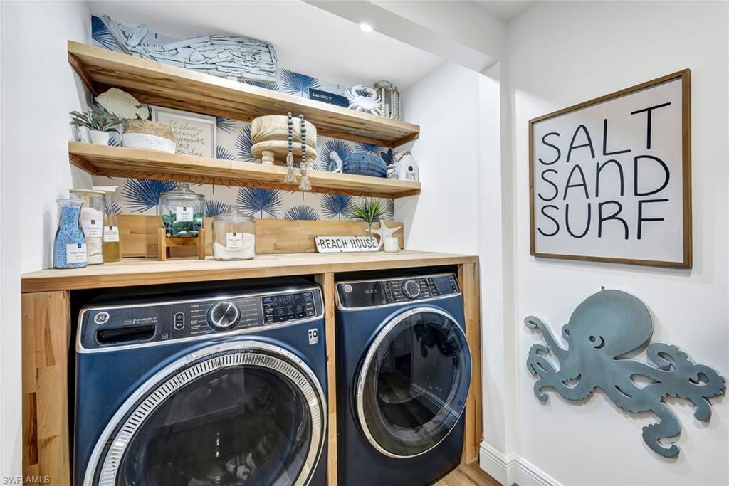 6549 Marissa Loop, Unit 21 Naples, FL 34108 - Photo 15 of 20 a view of washer and dryer with a kitchen area
