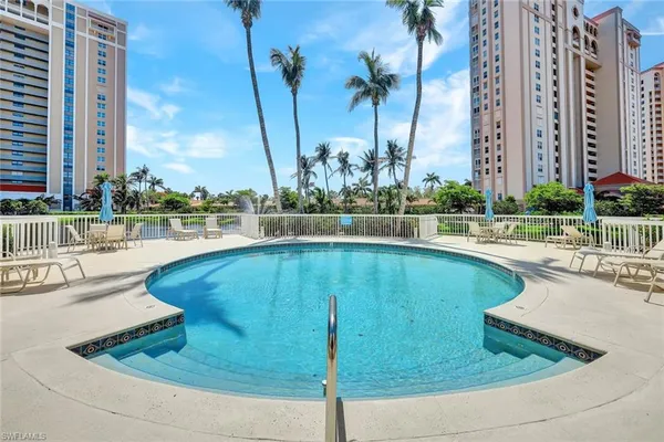 a swimming pool with outdoor seating