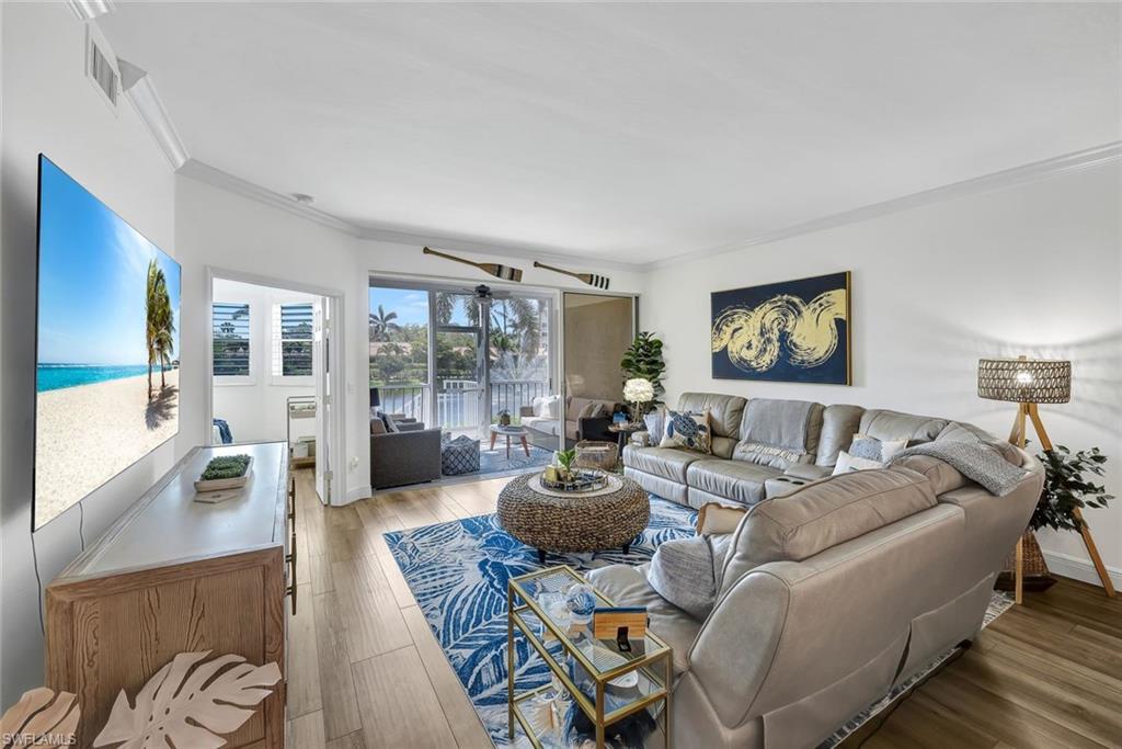 6549 Marissa Loop, Unit 21 Naples, FL 34108 - Photo 3 of 20 a living room with furniture and a large window