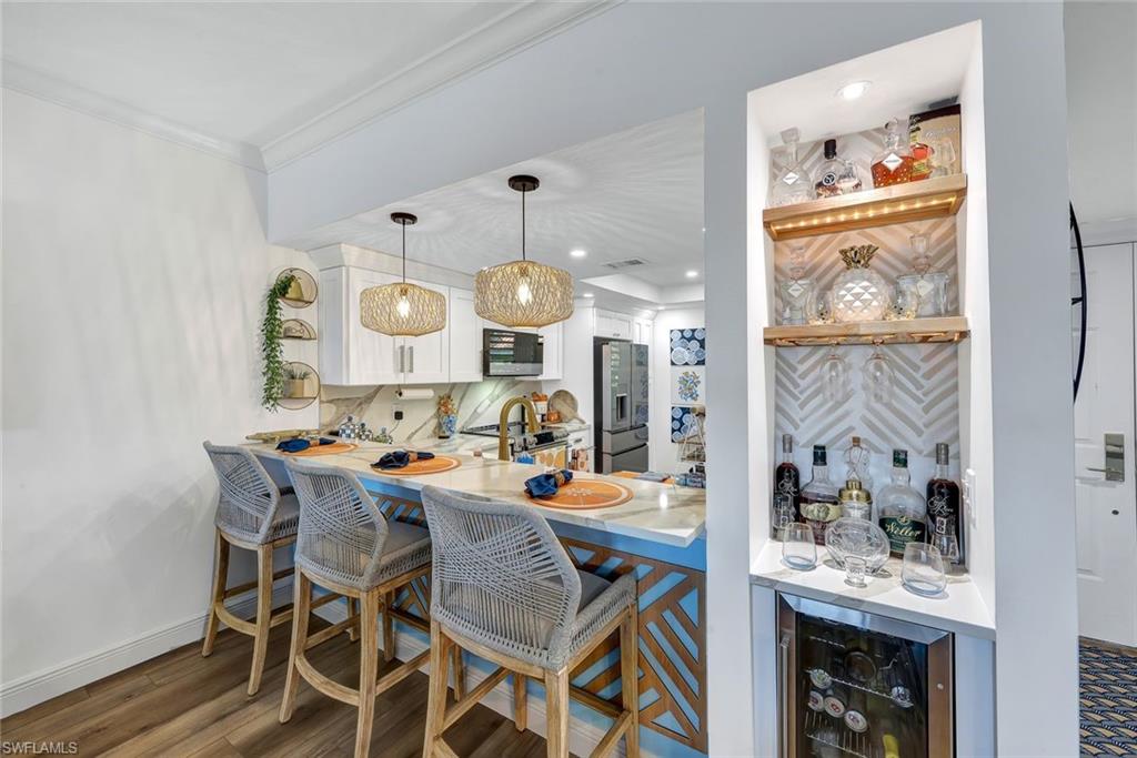6549 Marissa Loop, Unit 21 Naples, FL 34108 - Photo 6 of 20 a view of a dining area with furniture window and wooden floor