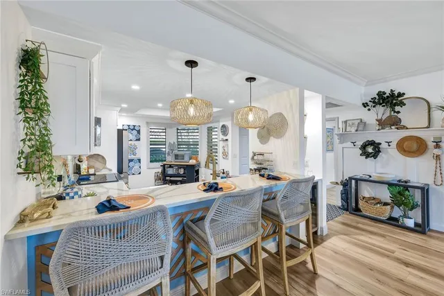 a very nice looking dining room with a large dining table and chairs with wooden floor