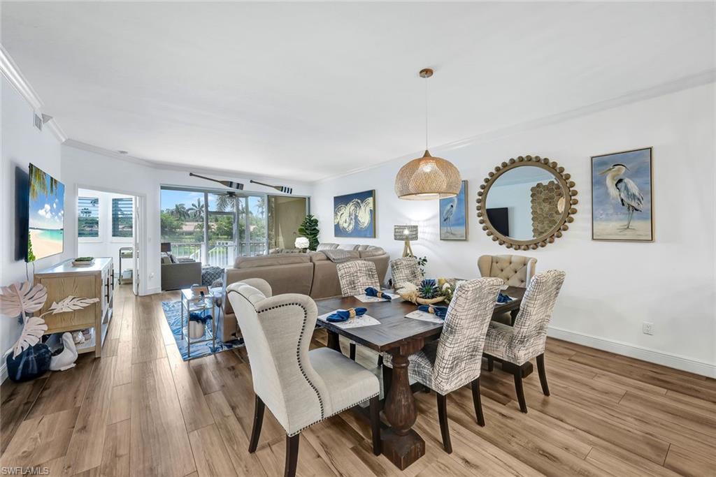 6549 Marissa Loop, Unit 21 Naples, FL 34108 - Photo 8 of 20 a view of a dining room with furniture window and wooden floor