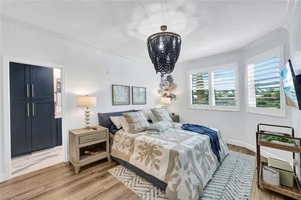 a bedroom with bed and a chandelier