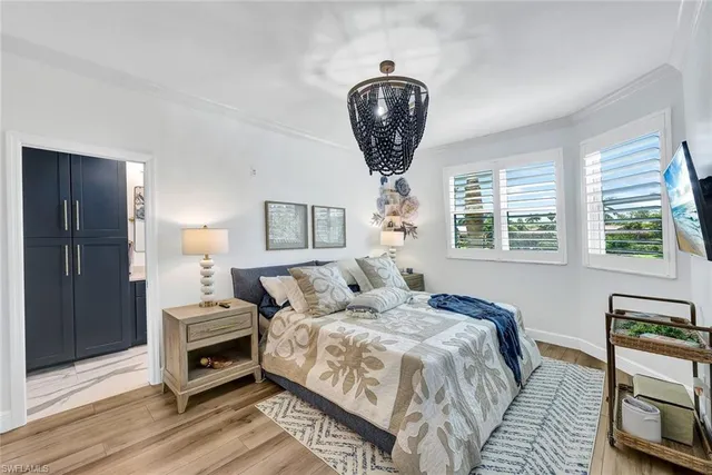 a bedroom with bed and a chandelier
