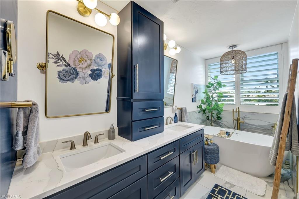 6549 Marissa Loop, Unit 21 Naples, FL 34108 - Photo 10 of 20 a bathroom with a double vanity sink and a mirror