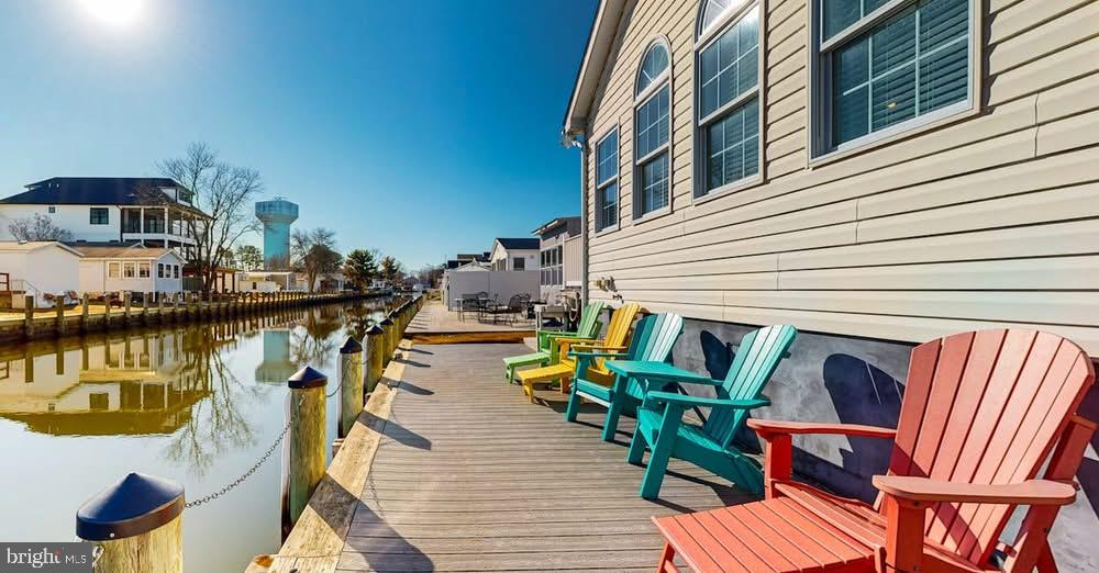 a view of balcony with chairs and wooden floor