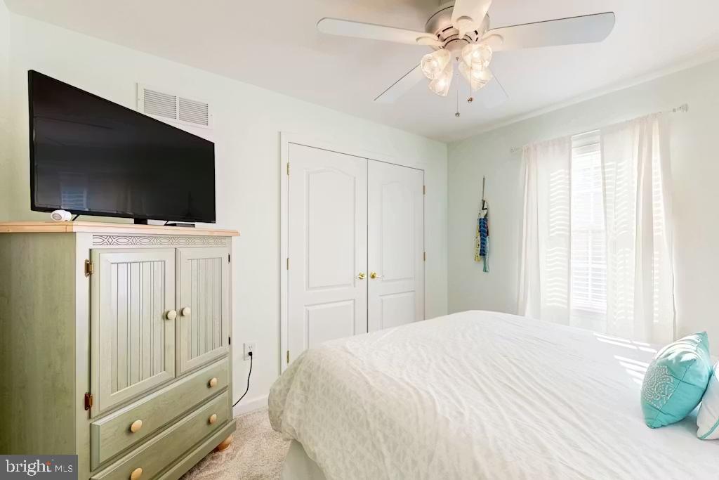37022 Blue Teal Road Selbyville, DE 19975 - Photo 11 of 20 a bedroom with a bed and a flat screen tv