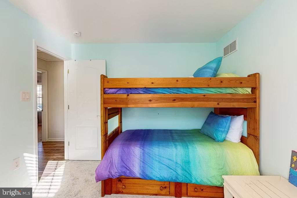 37022 Blue Teal Road Selbyville, DE 19975 - Photo 13 of 20 a bedroom with a bed and a mirror