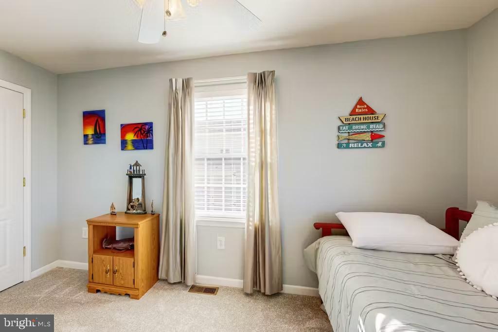 37022 Blue Teal Road Selbyville, DE 19975 - Photo 15 of 20 a bedroom with a bed and a window