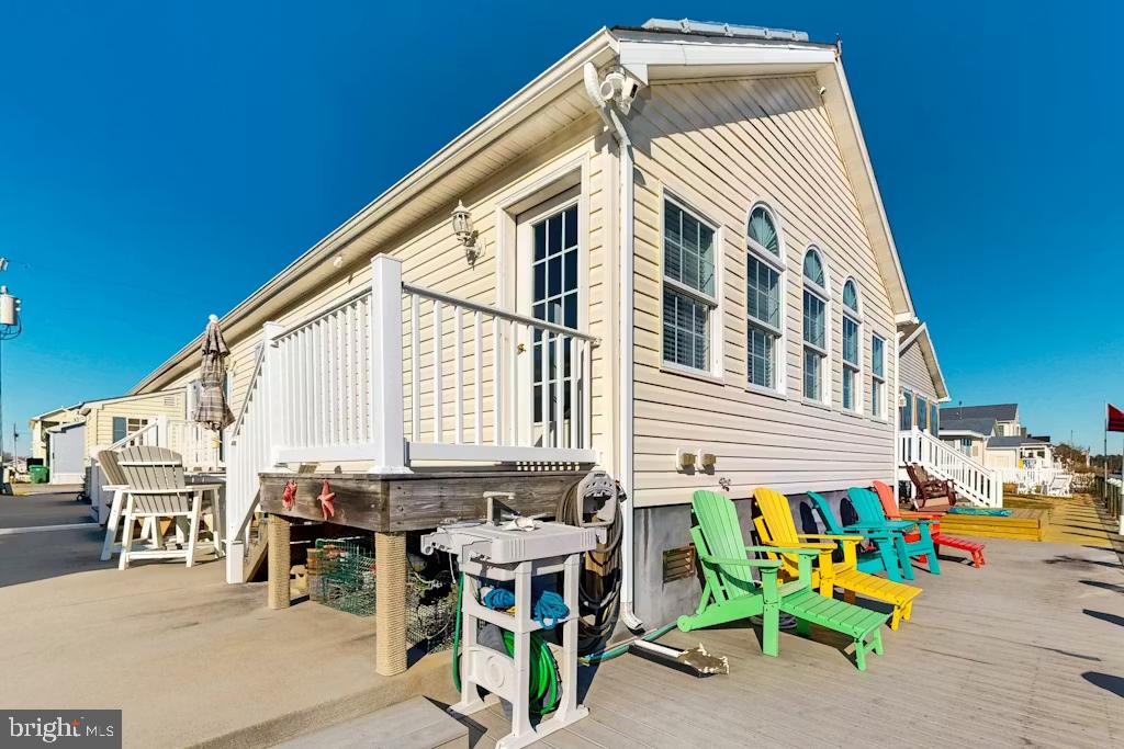 37022 Blue Teal Road Selbyville, DE 19975 - Photo 2 of 20 a front view of a house with outdoor seating