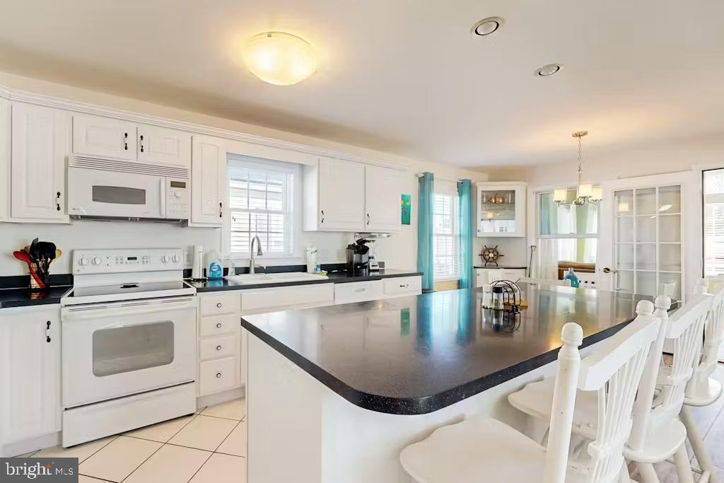 37022 Blue Teal Road Selbyville, DE 19975 - Photo 4 of 20 a kitchen with counter space appliances a sink and cabinets