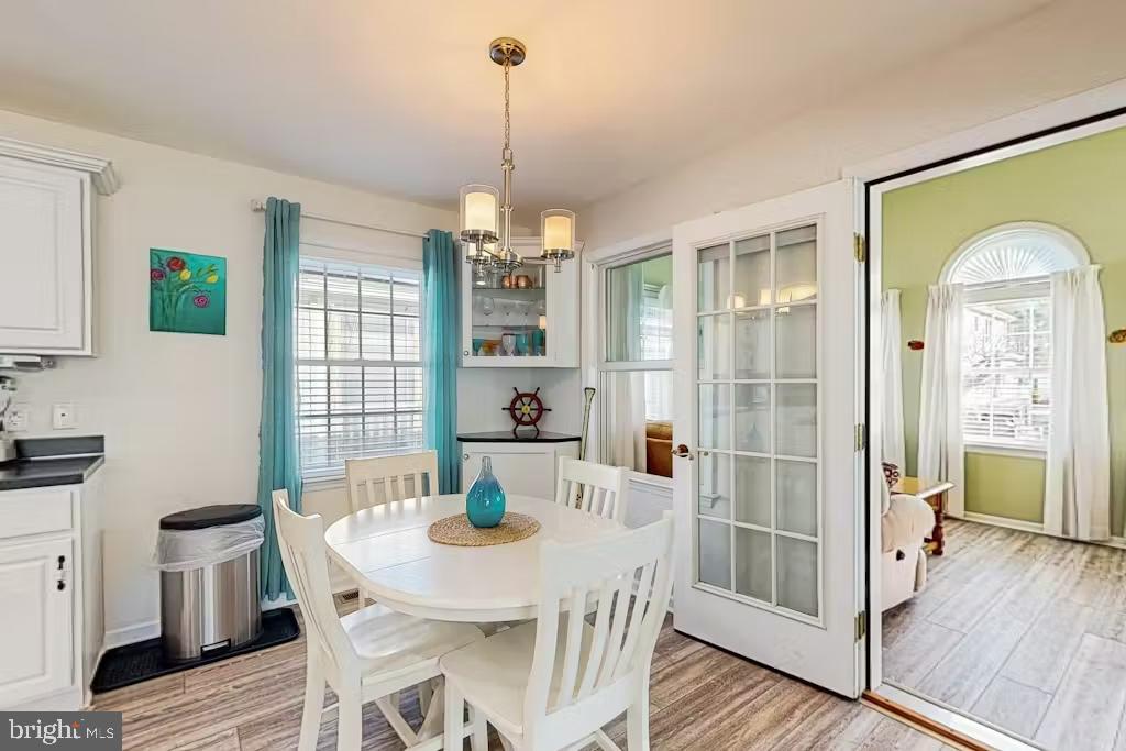 37022 Blue Teal Road Selbyville, DE 19975 - Photo 6 of 20 a view of a dining room with furniture window and wooden floor