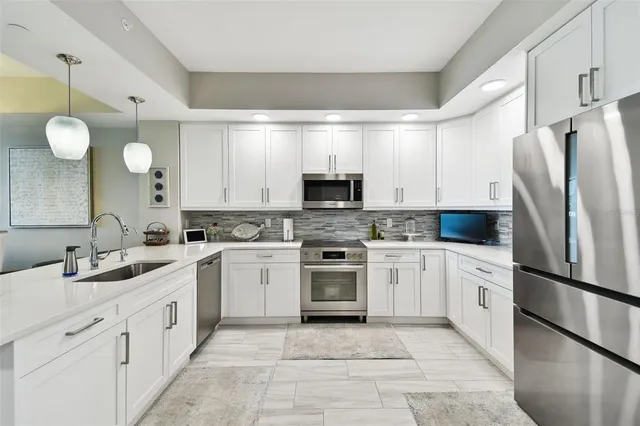 a kitchen with white cabinets and white appliances