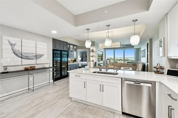 a kitchen with stainless steel appliances kitchen island granite countertop a sink cabinets and wooden floor