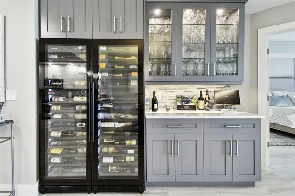 a kitchen with granite countertop a refrigerator and cabinets