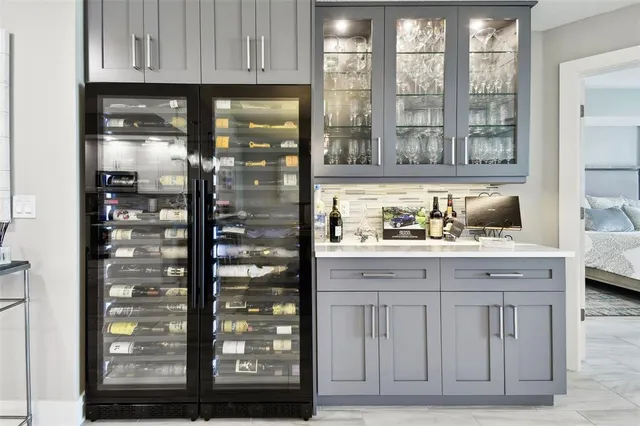 a kitchen with granite countertop a refrigerator and cabinets
