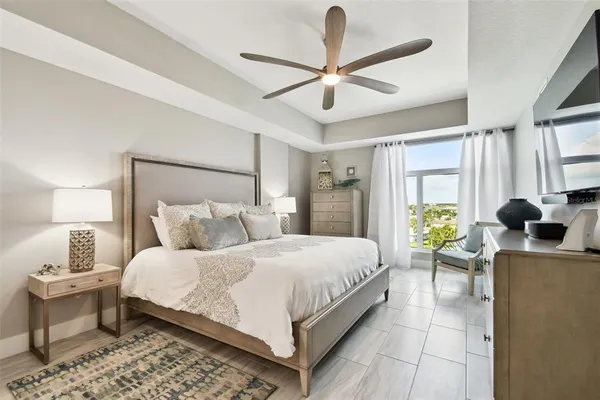 a bedroom with a bed and a chandelier