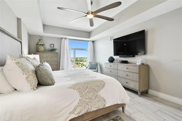 a bedroom with a bed and a flat screen tv