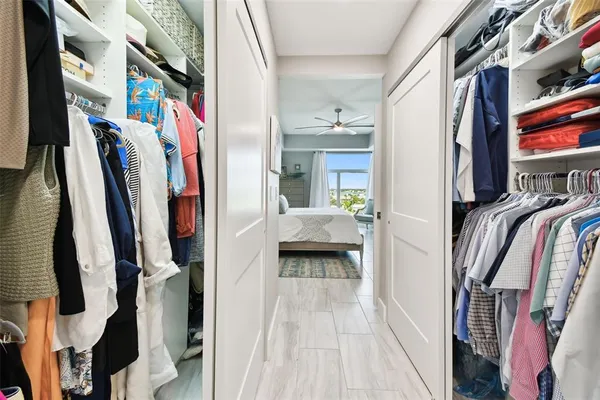 a view of walk in closet with clothes and shoes