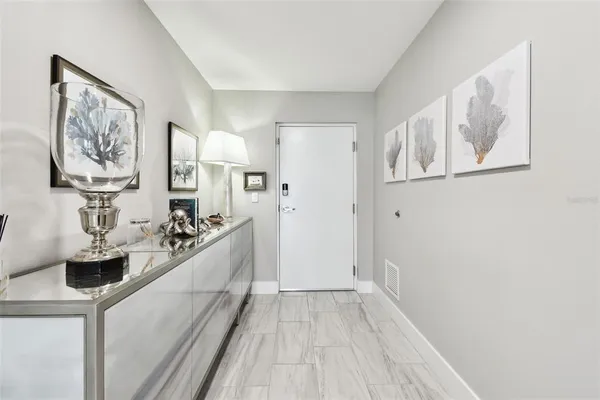 a view of a kitchen with fridge and wooden floor
