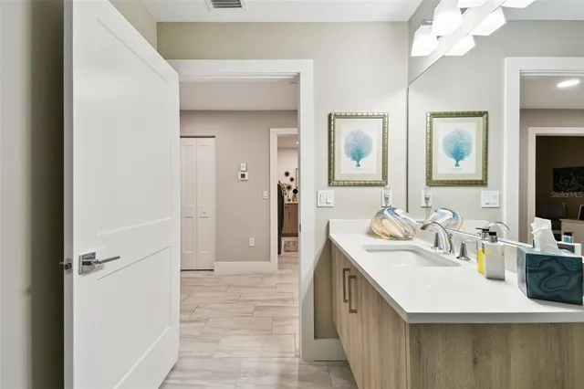 a bathroom with a sink a mirror and a shower