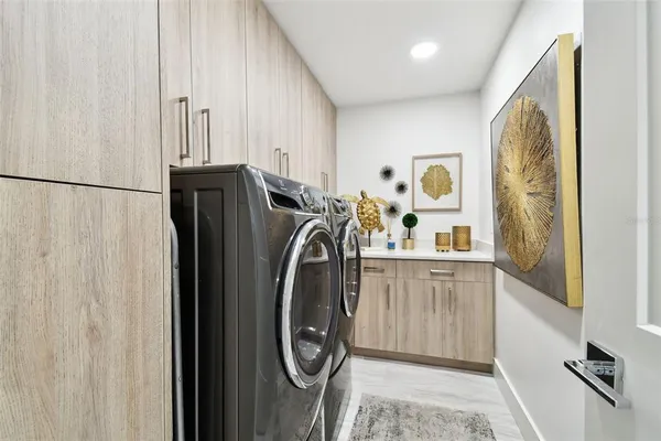 a utility room with sink dryer and washer