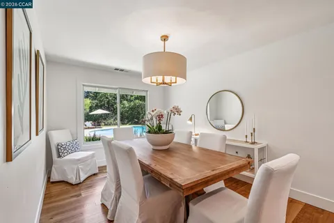 a kitchen with stainless steel appliances granite countertop a lot of counter space and wooden floors