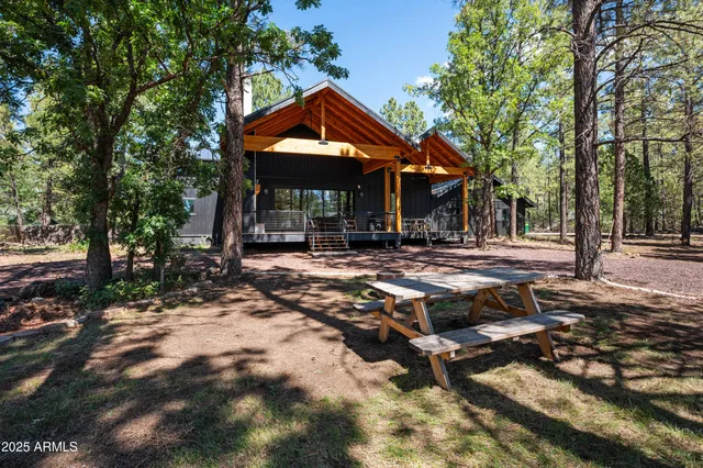 a backyard of a house with barbeque oven table and chairs