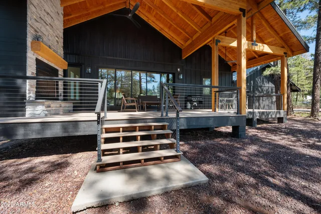 a view of backyard with deck and wooden floor