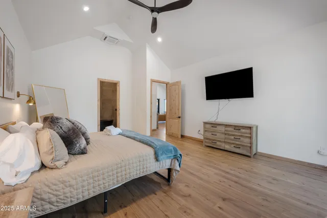 a bedroom with a bed and a flat screen tv