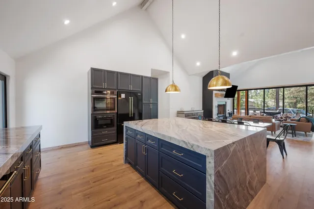 a kitchen with kitchen island a sink appliances and a counter top space