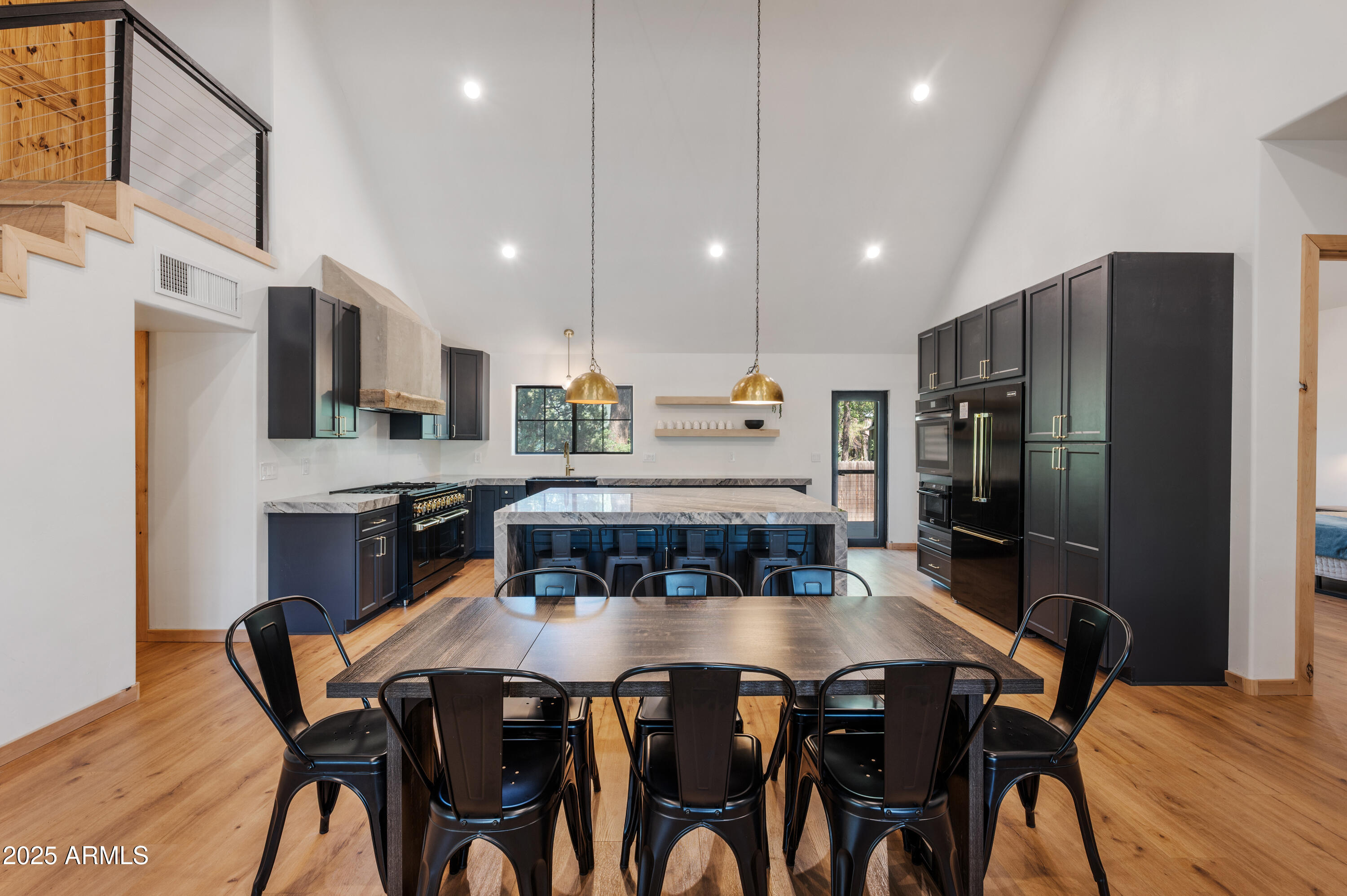 820 West Apache Lane Lakeside, AZ 85929 - Photo 20 of 40 a kitchen with stainless steel appliances granite countertop a stove a refrigerator a kitchen island a dining table and chairs with wooden floor