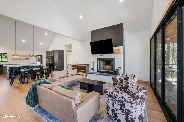 a living room with furniture a flat screen tv and a fireplace