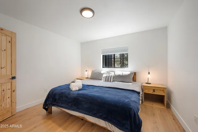 a bedroom with a bed and a night stand