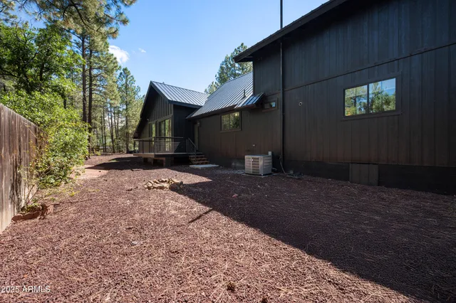 a backyard of a house with large trees